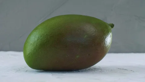 Appetizing fresh ripe mango isolated on the grey background Stock Footage 128181975