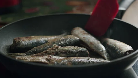 Appetizing fried sardines on the hot pan Stock Footage 144883472
