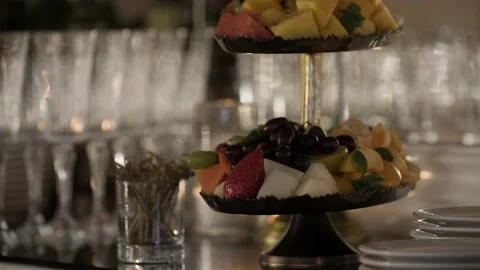 Appetizing fruit plate and empty clean glasses in the background. Stock Footage 194998095