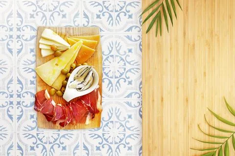 Appetizing ham, several types of cheeses with capers and olives Stock Photos