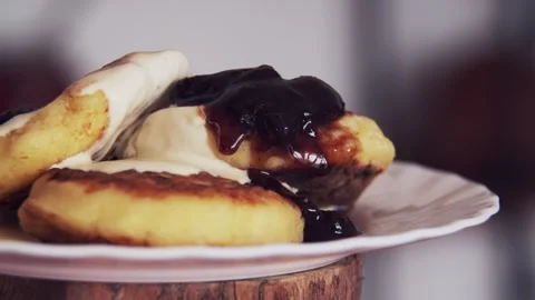 Appetizing homemade cheesecakes with sour cream on which strawberry jam is Stock Footage 241564483
