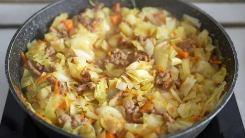 Appetizing hot chopped cabbage sautéed with minced Stock Footage 347855209