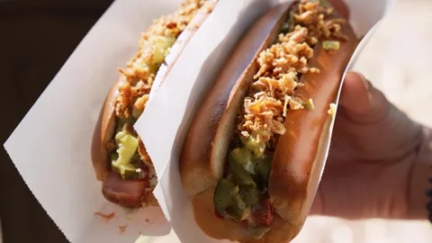 Appetizing hot dogs in hand. Close-up Stock Footage 280081673