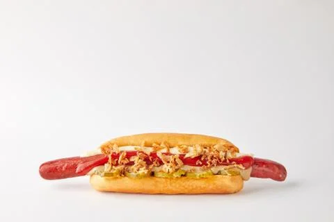 Appetizing hotdog lying on a white background Stock Photos