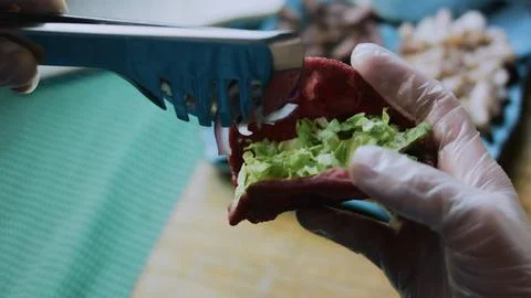 Appetizing ingredient study: adding creamy pickle sauce to a lettuce wrap Stock Photos
