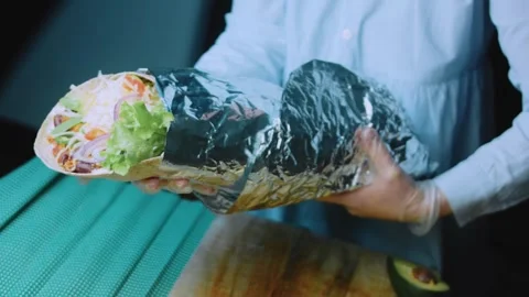 Appetizing ingredient view: displaying a large filled burrito Stock Footage 342168300