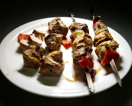 Appetizing kebab with bell pepper on white plate, close up. barbecue on a white Stock Photos