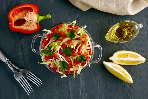 An appetizing light salad of white cabbage, bell pepper and parsley dressed.. Stock Photos