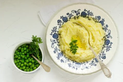 Appetizing mashed potatoes with butter and parsley. Rustic style. Stock Photos
