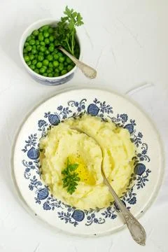 Appetizing mashed potatoes with butter and parsley. Rustic style. Stock Photos