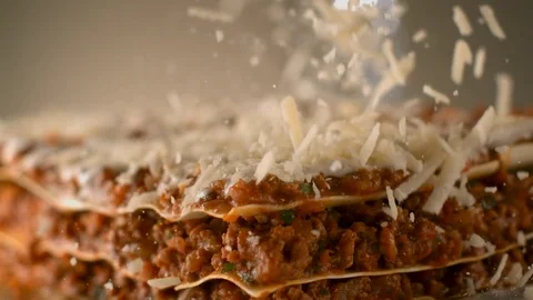 Appetizing meat lasagna is sprinkled with pieces of grated cheese. Stock Footage 83724077