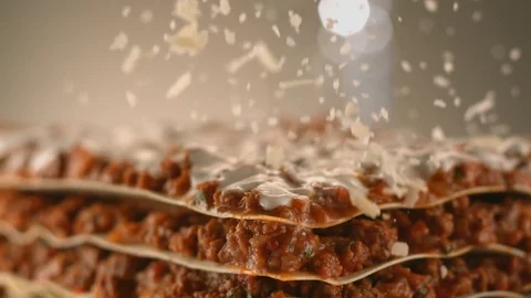 Appetizing meat lasagna is sprinkled with pieces of grated cheese. Stock Footage 83724166