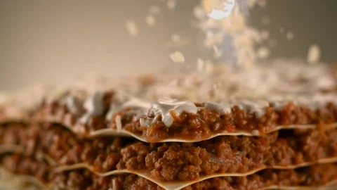 Appetizing meat lasagna is sprinkled with pieces of grated cheese. Stock Footage 83724172