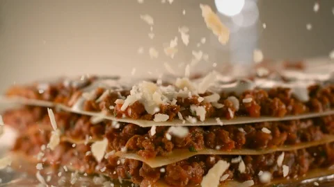 Appetizing meat lasagna is sprinkled with pieces of grated cheese. Stock Footage 83724237