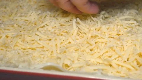 Appetizing meat lasagna is sprinkled with pieces of grated cheese. Parmesan.Very Stock Footage 105542589