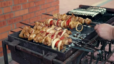Appetizing meat skewers grilling with smoke on barbecue Stock Footage 343385293