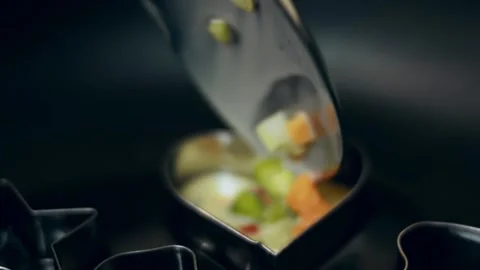 Appetizing metal cutters shaping individual omelets in a frying pan in macro, 4K Stock Footage 341107968