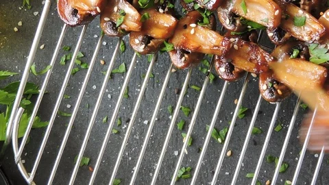 Appetizing mushroom kebabs put on the grill. Stock Footage 102062344