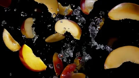 Appetizing peach slices fly up in a spray of water Video stock 302212932