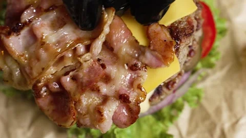 Appetizing piece of bacon close-up in burger Stock Footage 297004138