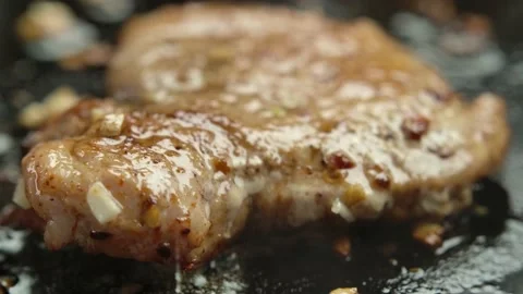 An appetizing piece of meat fillet is fried in a pan in hot oil Stock Footage 237776376