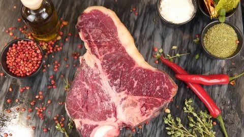 Appetizing piece of meat sprinkled with salt and pepper with seasoning Video stock 89555478