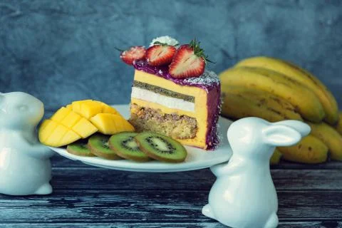 Appetizing a piece of mousse cake decorated with strawberries, blueberries an Stock Photos