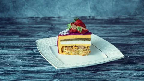 Appetizing a piece of mousse cake decorated with strawberries, blueberries an Stock Photos
