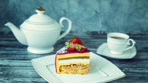Appetizing a piece of mousse cake decorated with strawberries, blueberries an Stock Photos