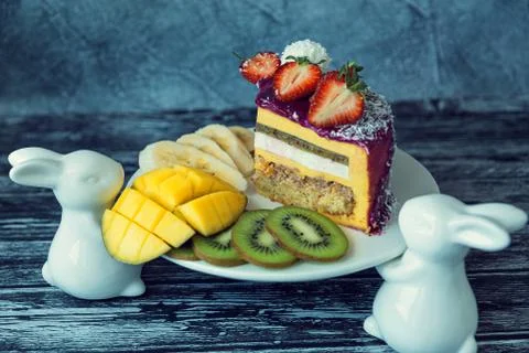 Appetizing a piece of mousse cake decorated with strawberries, blueberries an Stock Photos