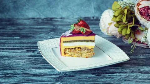 Appetizing a piece of mousse cake decorated with strawberries, blueberries an Stock Photos