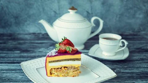Appetizing a piece of mousse cake decorated with strawberries, blueberries an Stock Photos