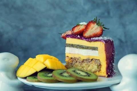 Appetizing a piece of mousse cake decorated with strawberries, blueberries an Stock Photos