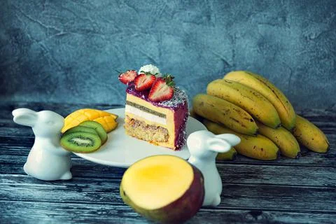 Appetizing a piece of mousse cake decorated with strawberries, blueberries an Stock Photos