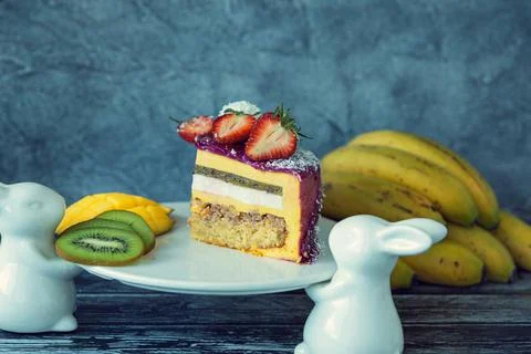 Appetizing a piece of mousse cake decorated with strawberries, blueberries an Stock Photos