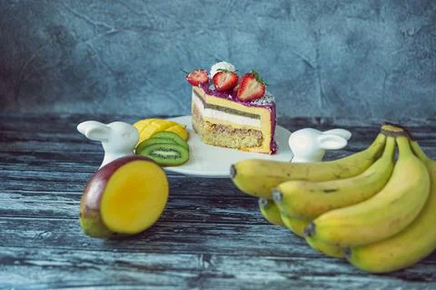 Appetizing a piece of mousse cake decorated with strawberries, blueberries an Stock Photos