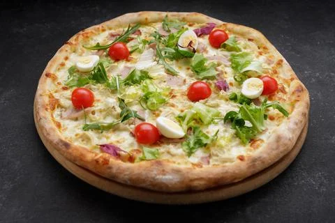 Appetizing Pizza Caesar, with meat, eggs, tomatoes and herbs Stock Photos