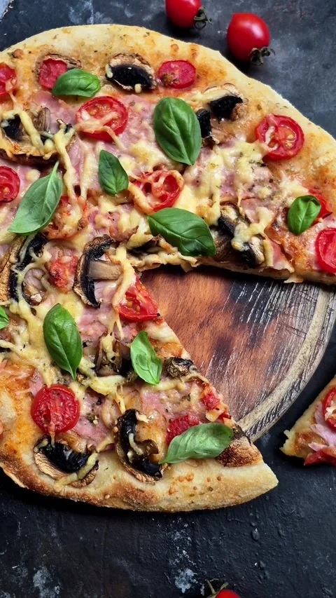 Appetizing pizza with ham, tomatoes and cheese close-up. Stock Footage 310104988