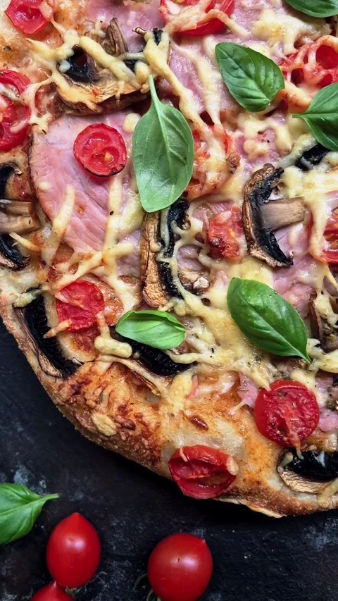 Appetizing pizza with ham, tomatoes Stock Footage 310104703