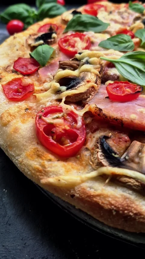 Appetizing pizza with ham, tomatoes Stock Footage 310104799