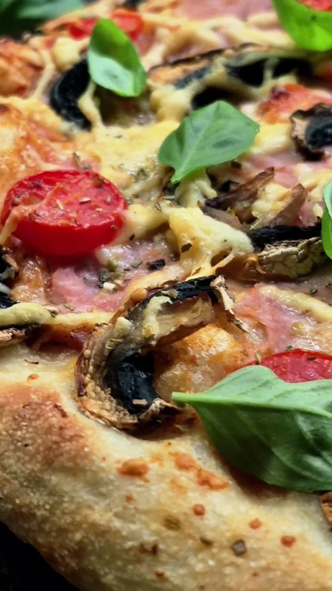 Appetizing pizza with ham, tomatoes Stock Footage 310104845