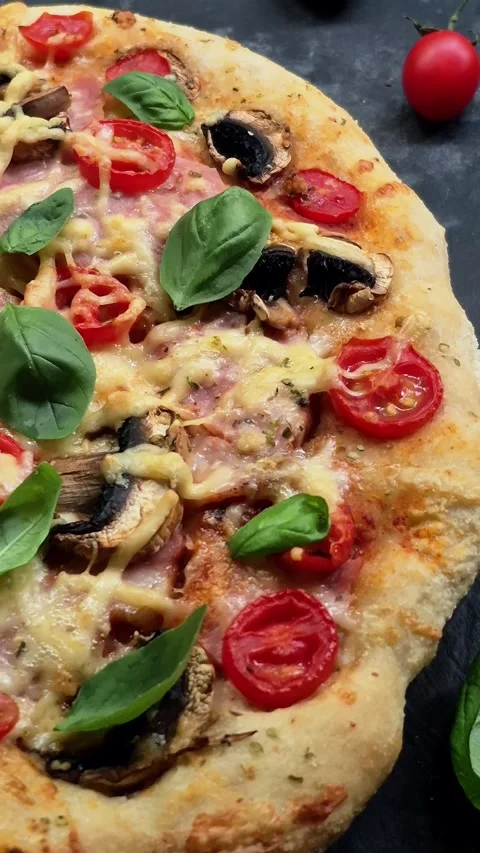 Appetizing pizza with ham, tomatoes Stock Footage 310104874