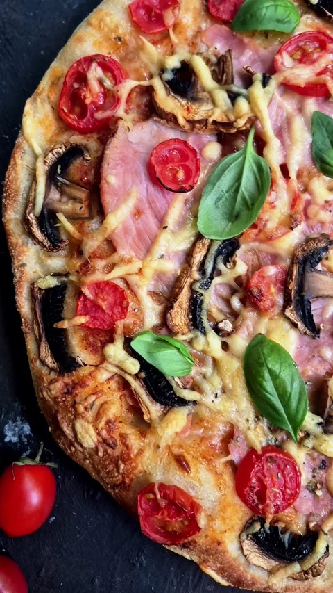 Appetizing pizza with ham, tomatoes Stock Footage 310104976