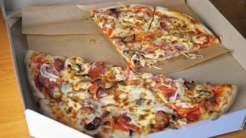 Appetizing pizza lies in a box, a few pieces of pizza are missing. Stock Footage 202192161