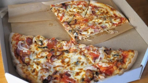 Appetizing pizza lies in a box, a few pieces of pizza are missing Video stock 202365561