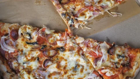 Appetizing pizza lies in a box, a few pieces of pizza are missing Video stock 203308326