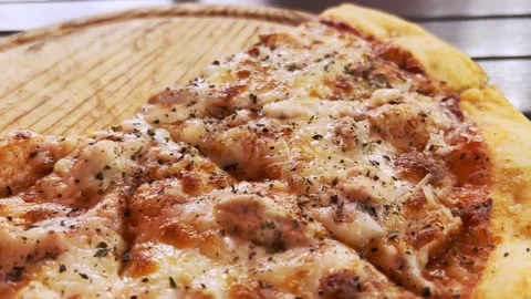 An appetizing pizza with melted cheese, along the surface of which the camera Stock Footage 208951329