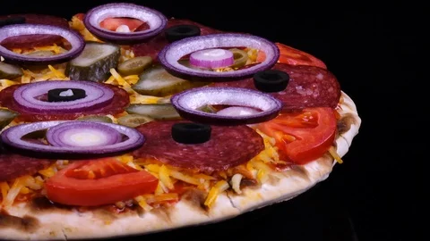 Appetizing pizza with pickles, salami, olives, cheese, tomatoes and onion rings Stock Footage 92194572