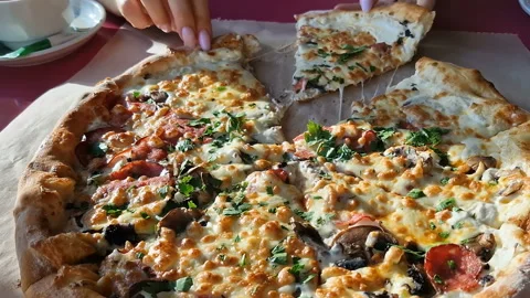 Appetizing pizza on a table in a cafe. Stock Footage 240924074