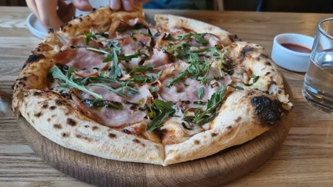 Appetizing pizza on a table in a cafe. Stock Footage 241086647